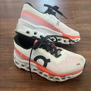 On Running White and orange Athletic Shoes - cloud monster